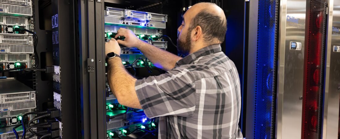 Technician monitoring a high-performance GPU computing cluster